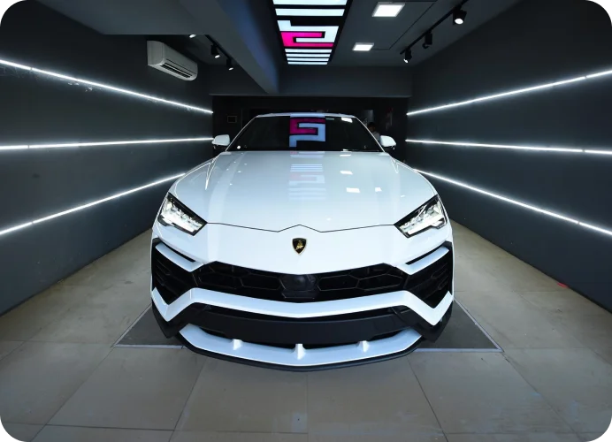 White Lamborghini Urus inside a lighting tunnel