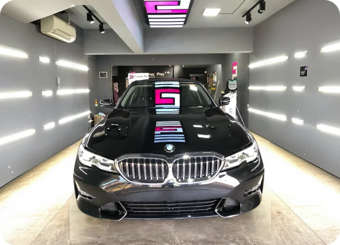 Black BMW sedan in a detailing bay