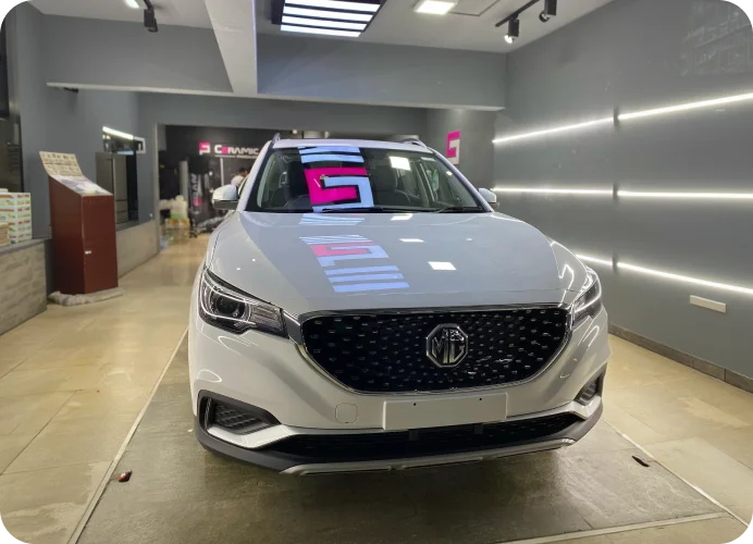 White MG SUV inside a ceramic coating studio